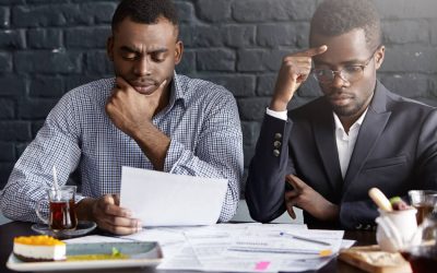 two-worried-serious-afro-american-businessmen-working-through-papers-discussing-financial-report-having-concentrated-looks(1)